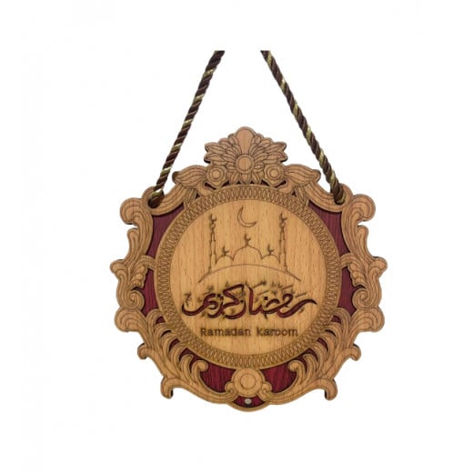 Hanging a wooden plaque decorated with Ramadan Kareem